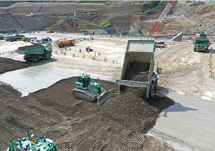 An automated dump truck and automated bulldozer